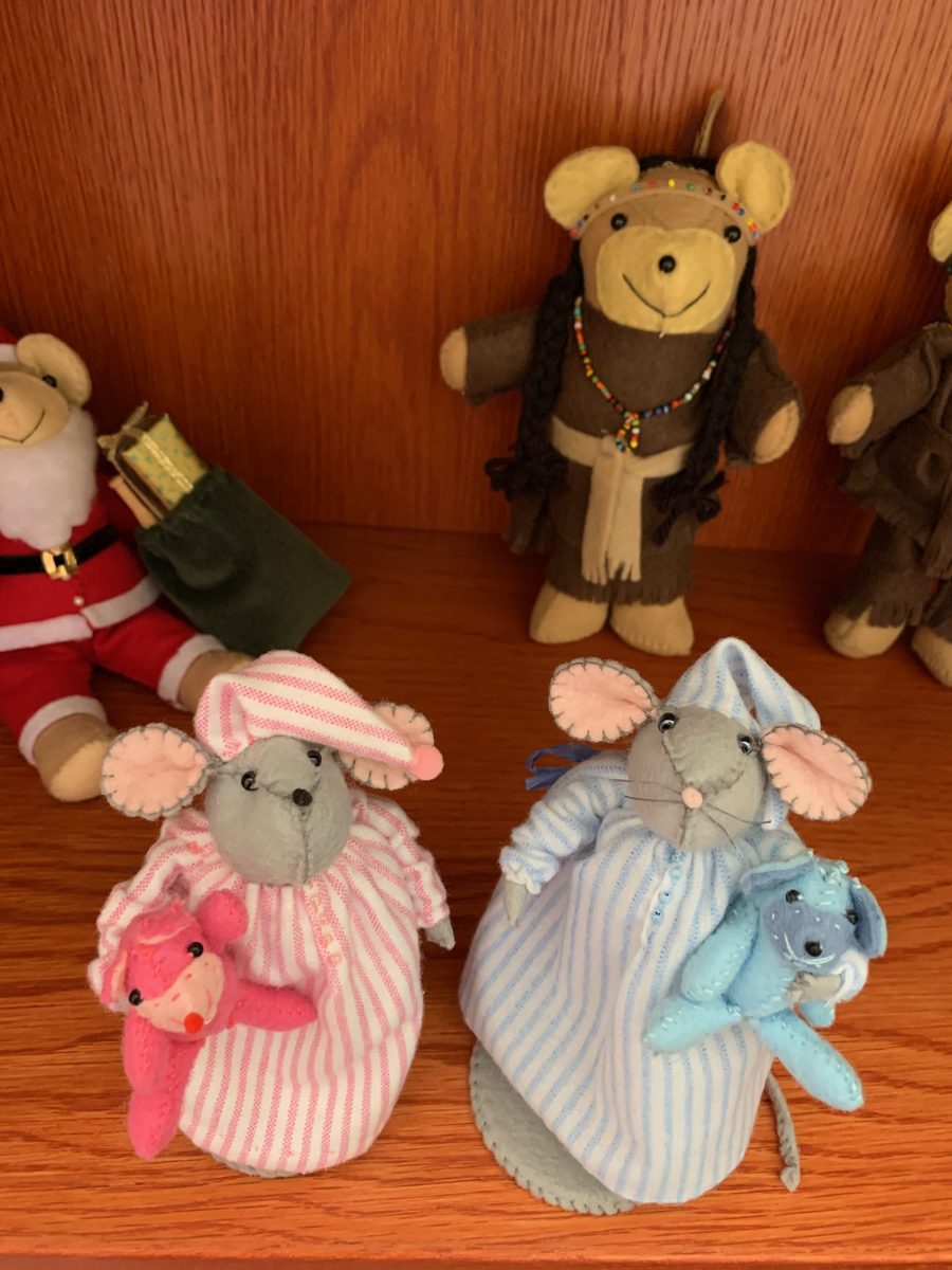 Holiday bears and sleepytime mice gathered together in a cozy seasonal display.