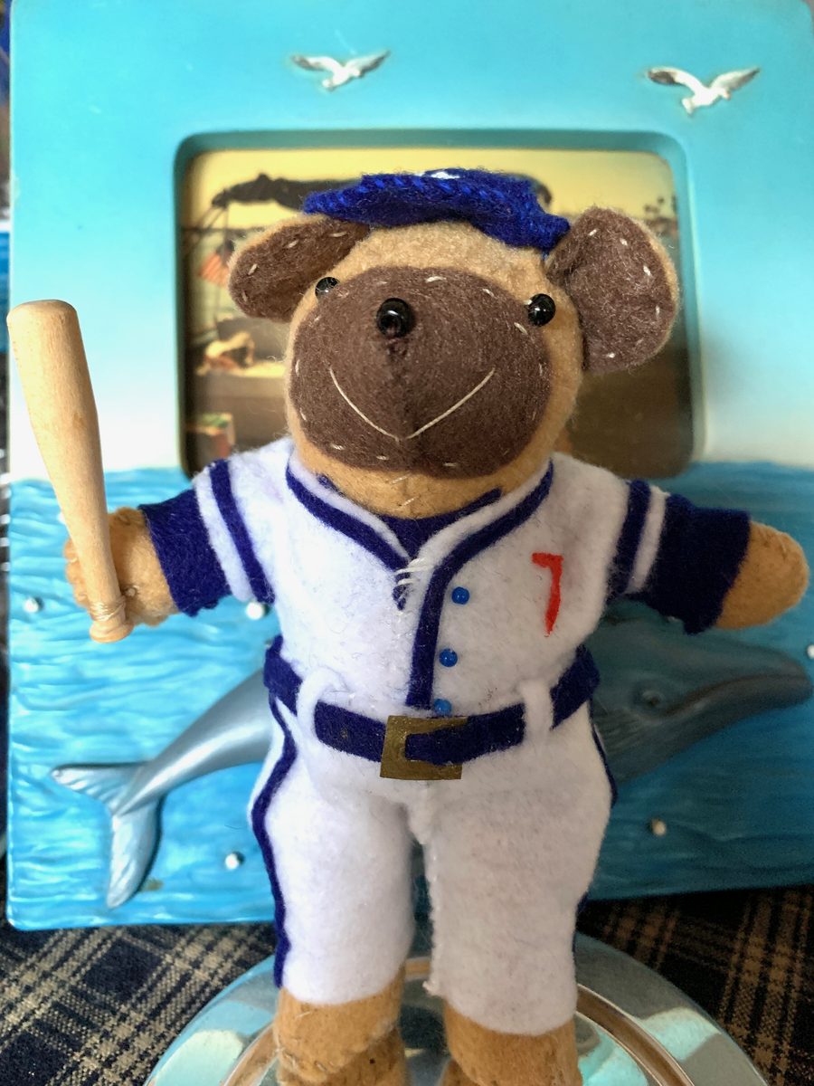 A sports-themed handmade bear or doll with custom character details.