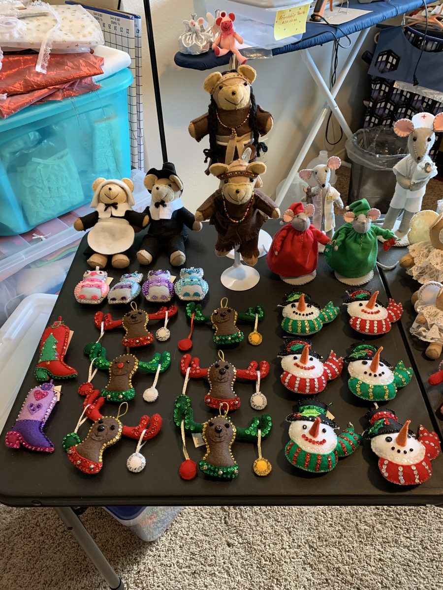 A craft-fair-style arrangement with ornaments, dolls, and seasonal handmade pieces.