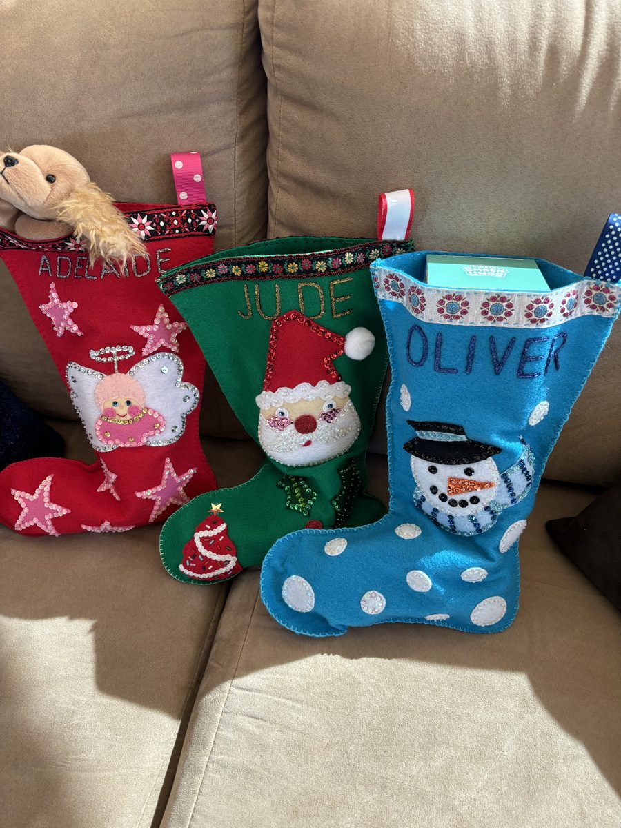 Personalized Christmas stockings with bold holiday color and hand-finished details.