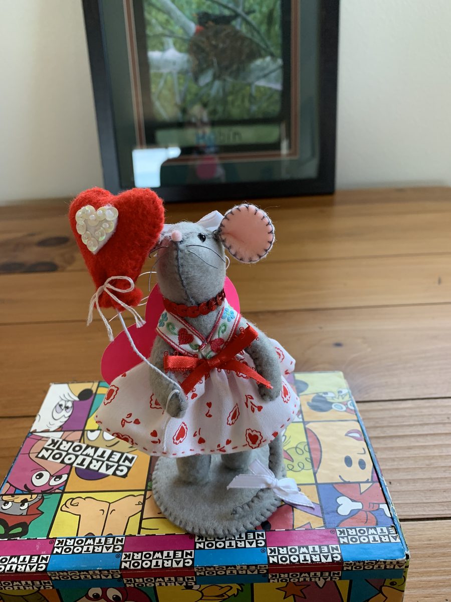 A Valentine-themed handmade mouse doll in red and pink seasonal details.
