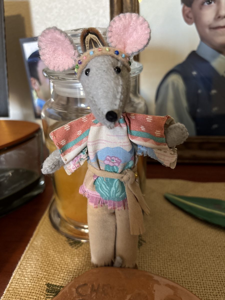 A handmade Native American mouse with detailed outfit and character styling.