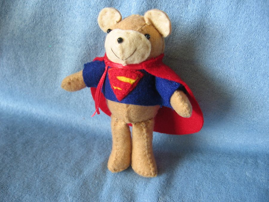 A handmade superhero bear pair, ready for heroic shelf duty.