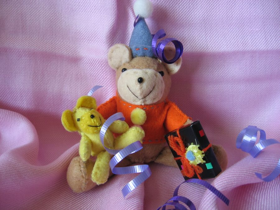 Handmade birthday bears dressed for celebration and tiny party chaos.
